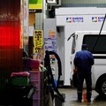 FILE PHOTO: A staff fills up gas in a customer's car at a gasoline station in Tokyo, Japan, March 25, 2026. REUTERS/Kim Kyung-Hoon/File Photo