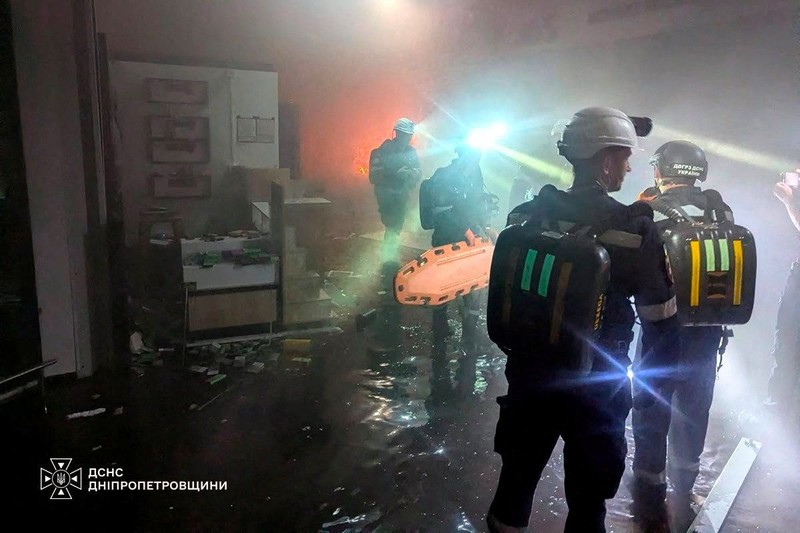 Petugas pemadam kebakaran bekerja di lokasi pusat perbelanjaan yang dihantam serangan pesawat nirawak Rusia di Kryvyi Rih, di tengah serangan Rusia terhadap Ukraina, di wilayah Dnipropetrovsk, Ukraina, pada 21 Agustus 2026. (Telegram/Handout via REUTERS)