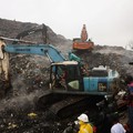 Rescue workers search through debris at a landfill after a landslide caused by heavy overnight rains killed people in the Dar es Salam area in Conakry, Guinea, August 23, 2026. REUTERS/Souleymane Camara