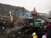 Rescue workers search through debris at a landfill after a landslide caused by heavy overnight rains killed people in the Dar es Salam area in Conakry, Guinea, August 23, 2026. REUTERS/Souleymane Camara