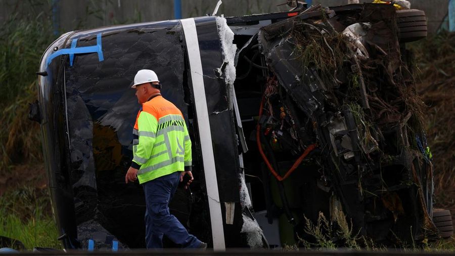 Seorang petugas darurat melangkah melewati buntang kendaraan di letak kecelakaan bus di jalan raya A28 nan mengakibatkan banyak korban, di Weesp, Belanda, pada 24 Agustus 2026.