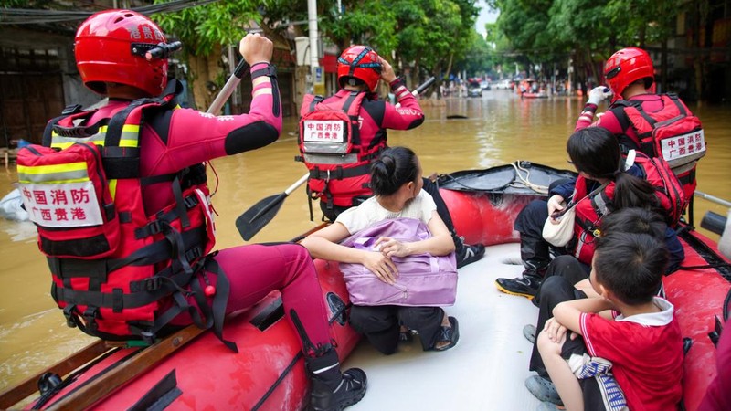 Rescue workers evacuate flood-affected residents by boat after heavy rainfall brought by typhoon Narra caused flooding in Longzhou county, Chongzuo, Guangxi Zhuang Autonomous Region, China August 24, 2026. cnsphoto via REUTERS   ATTENTION EDITORS - T