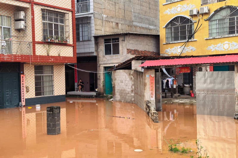 Floodwaters inundate a street lined with residential buildings after heavy rainfall brought by typhoon Narra caused flooding in Ningming county, Chongzuo, Guangxi Zhuang Autonomous Region, China August 24, 2026. cnsphoto via REUTERS   ATTENTION EDITORS - THIS IMAGE WAS PROVIDED BY A THIRD PARTY. CHINA OUT. NO COMMERCIAL OR EDITORIAL SALES IN CHINA