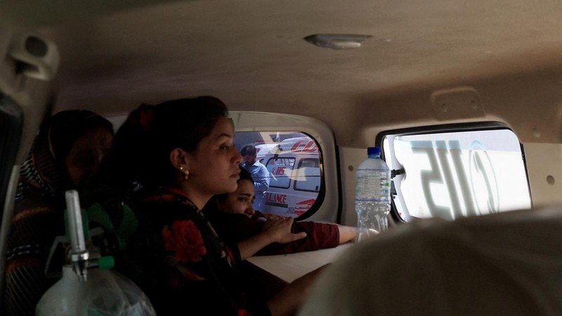 Javeria, ibu dari seorang bayi yang menjadi korban, memeluk peti jenazah berisi jasad bayinya di dalam ambulans setelah kebakaran maut di rumah sakit Pakistan Institute of Medical Sciences (PIMS) di Islamabad, Pakistan, pada 26 Agustus 2026.