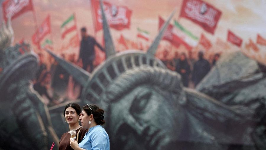 FILE PHOTO: People walk past an anti-U.S. billboard on a street in Tehran, Iran, August 3, 2026. Majid Asgaripour/WANA (West Asia News Agency) via REUTERS    ATTENTION EDITORS - THIS PICTURE WAS PROVIDED BY A THIRD PARTY. ISRAEL OUT. NO COMMERCIAL OR