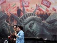 FILE PHOTO: People walk past an anti-U.S. billboard on a street in Tehran, Iran, August 3, 2026. Majid Asgaripour/WANA (West Asia News Agency) via REUTERS    ATTENTION EDITORS - THIS PICTURE WAS PROVIDED BY A THIRD PARTY. ISRAEL OUT. NO COMMERCIAL OR