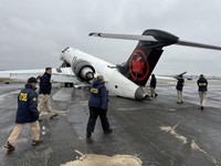 FILE PHOTO: National Transportation Safety Board (NTSB) investigators inspect the wreckage of an Air Canada Express jet that collided with a fire truck at LaGuardia Airport in Queens, New York, U.S., March 23, 2026. NTSB/Handout via REUTERS   THIS IM