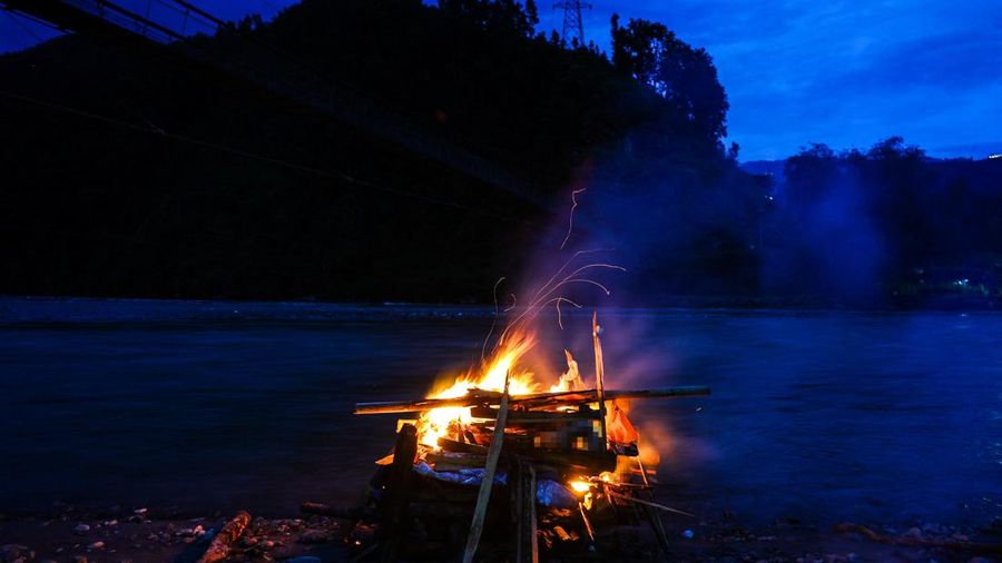 Api pembakaran jenazah Prabita Roila (32 tahun)—yang meninggal dunia akibat banjir bandang dan tanah longsor mematikan—menyala di tepi Sungai Suryamati di Trishuli, Distrik Nuwakot, Nepal, pada 30 Agustus 2026.