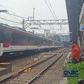 Seorang Petugas palang pintu perlintasan Kereta Api melihat Kereta Rel Listrik (KRL) Commuter Line melintasi di dekat Stasiun Karet, Jakarta, Selasa (1/9/2026). (CNBC Indonesia/Ferry Sandi)