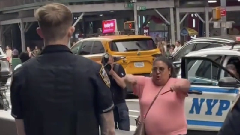 Seorang wanita mengarahkan pisau kearah petugas di kawasan Times Square, New York, Senin (31/8/2026). (Tangkapan Layar Video X/@PoliceIncident)