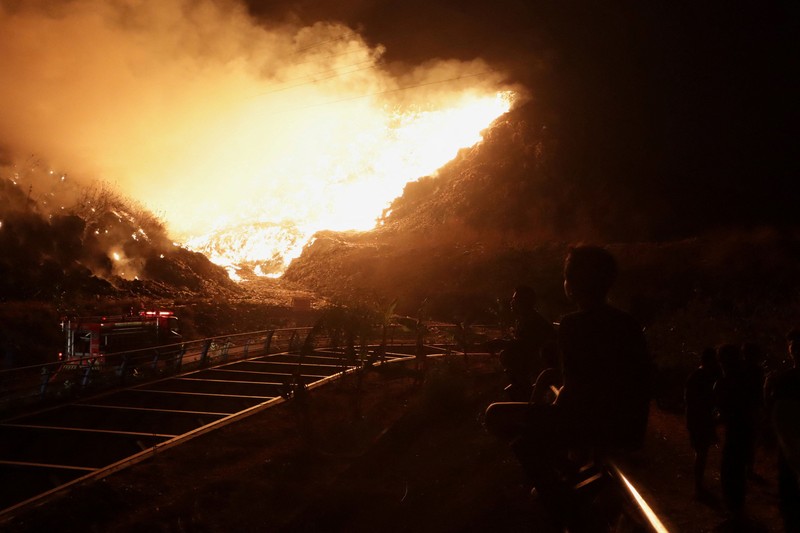 Petugas pemadam kebakaran menyemprotkan air dalam upaya memadamkan kebakaran di Tempat Pembuangan Akhir (TPA) Putri Cempo di Solo, Provinsi Jawa Tengah, Indonesia, pada 2 September 2026. (REUTERS/Stringer)