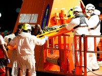 Rescuers help a migrant disembarking from a Spanish coast guard vessel at the port of Arguineguin, on the island of Gran Canaria, Spain, September 3, 2026. REUTERS/Borja Suarez