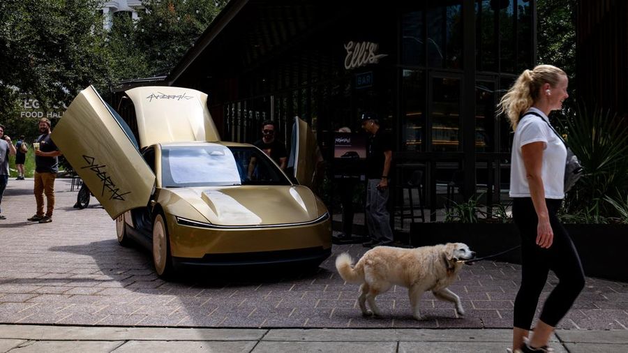 Sejumlah orang mengamati Tesla Cybercab berwarna emas yang diparkir di luar sebuah bar di pusat kota menjelang sebuah acara di Austin, Texas, AS, pada 3 September 2026.