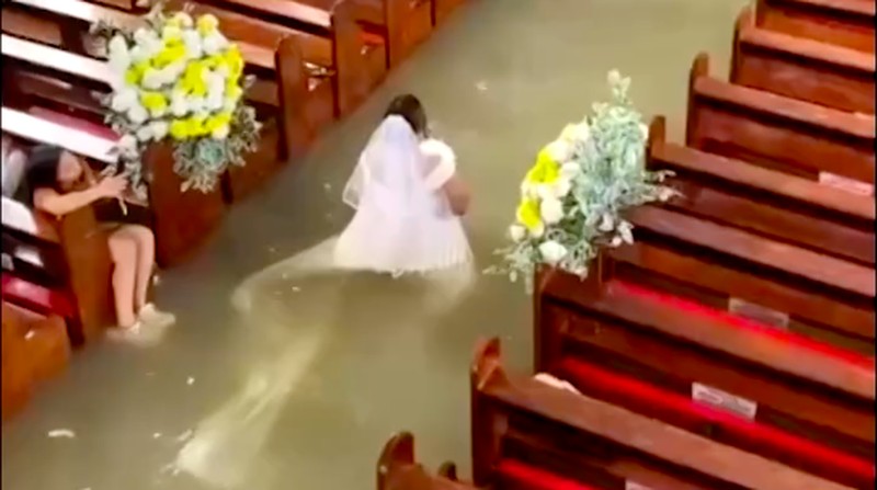 Seorang pengantin wanita Filipina berjalan di lorong Paroki St. Yohanes Pembaptis di tengah banjir di Hagonoy, provinsi Bulacan, Filipina, 1 September 2026. (Ang Tinig - St. John the Baptist Parish Hagonoy/Handout via REUTERS)