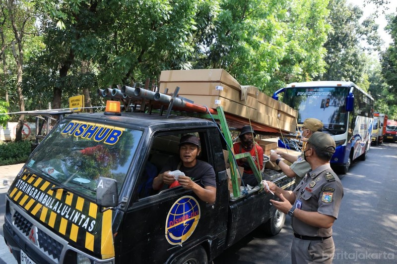 Kecamatan Cipayung membagikan masker ke sejumlah pengendara yang melintas di Jalan Raya Bina Marga, Cipayung, Senin (7/9/2026). (Dok. BeritaJakarta/Andri Widiyanto)