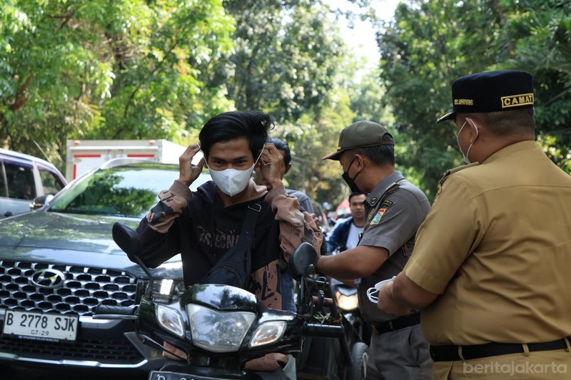 Kecamatan Cipayung membagikan masker ke sejumlah pengendara yang melintas di Jalan Raya Bina Marga, Cipayung, Senin (7/9/2026). (Dok. BeritaJakarta/Andri Widiyanto)