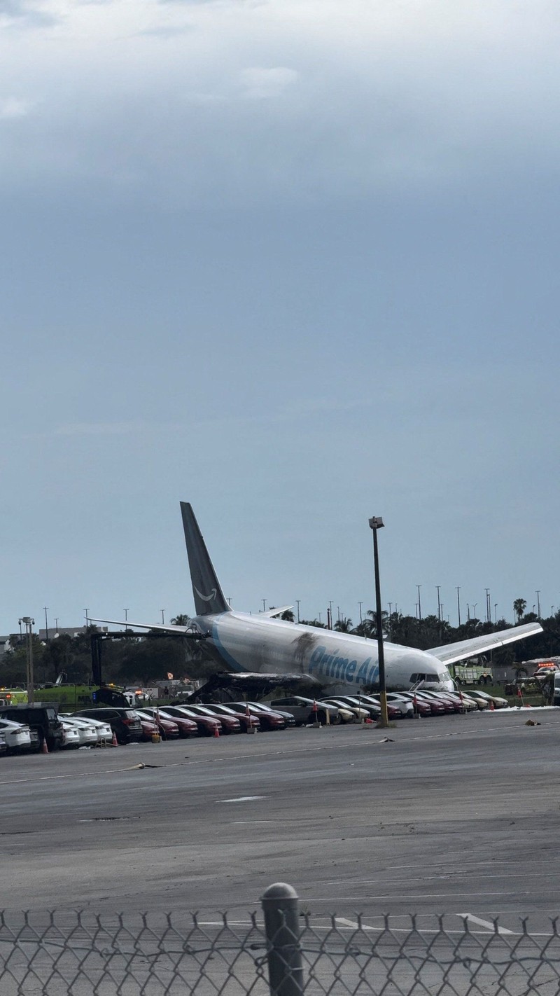 Tim darurat berada di dekat pesawat kargo Amazon Prime Air yang, menurut keterangan pejabat bandara, melampaui batas landasan pacu di Miami, Florida, AS, pada 6 September 2026. (Rohan Ellis/via REUTERS.)