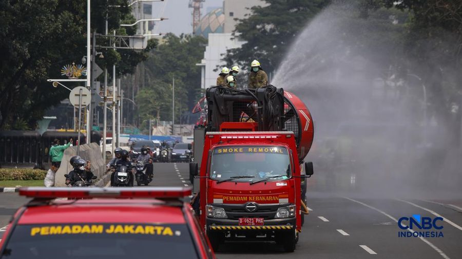 Petugas melakukan penyemprotan air dalam bentuk kabut halus bertekanan tinggi atau water mist di Jakarta, Selasa (8/9/2026).  (CNBC Indonesia/Faisal Rahman)