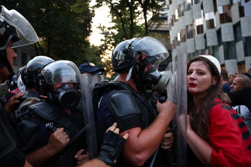Police cover themselves with their shields during a demonstration against the government, following months of protests against a planned luxury resort backed by a company linked to Jared Kushner, the son-in-law of U.S. President Donald Trump, on an environmentally sensitive part of the Adriatic coast, in Tirana, Albania, September 8, 2026. REUTERS/Florion Goga     TPX IMAGES OF THE DAY