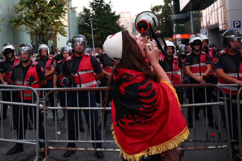 Police cover themselves with their shields during a demonstration against the government, following months of protests against a planned luxury resort backed by a company linked to Jared Kushner, the son-in-law of U.S. President Donald Trump, on an environmentally sensitive part of the Adriatic coast, in Tirana, Albania, September 8, 2026. REUTERS/Florion Goga     TPX IMAGES OF THE DAY