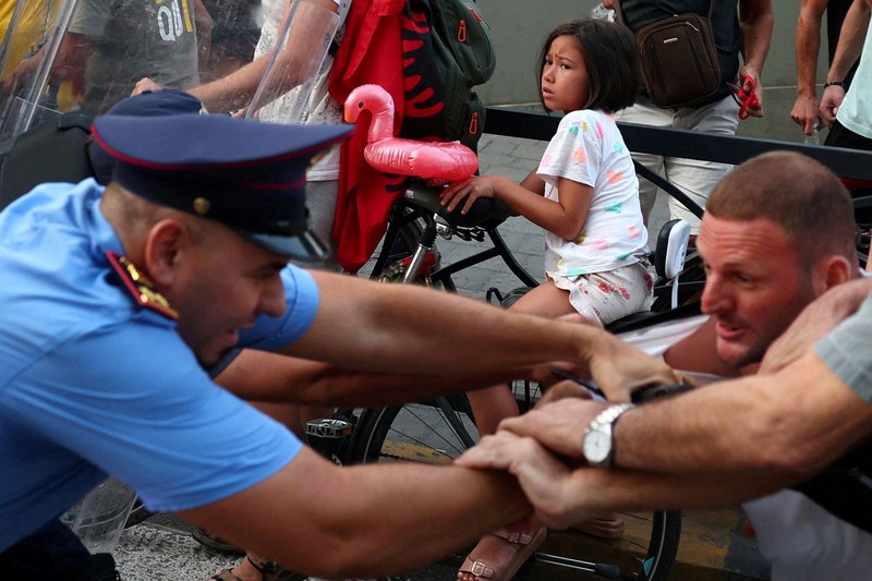 Police cover themselves with their shields during a demonstration against the government, following months of protests against a planned luxury resort backed by a company linked to Jared Kushner, the son-in-law of U.S. President Donald Trump, on an environmentally sensitive part of the Adriatic coast, in Tirana, Albania, September 8, 2026. REUTERS/Florion Goga     TPX IMAGES OF THE DAY