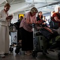 Stranded passengers use their phones after some departing flights were cancelled, at Heathrow Airport's Terminal 5 in London, Britain, September 8, 2026. Some departing flights at major British airports were disrupted on Tuesday after air traffic con