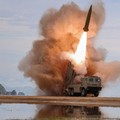 FILE PHOTO: A rocket launcher fires a munition during tests, involving an upgraded version of a 240-mm, 24-tube multiple rocket launcher system, tactical ballistic missiles, and a 155-mm self-propelled howitzer, overseen by North Korean leader Kim Jo