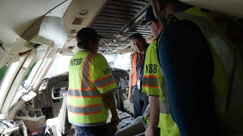 Para penyelidik National Transportation Safety Board (NTSB) memeriksa lokasi tempat pesawat kargo Amazon Prime Air melampaui batas landasan pacu di Bandara Internasional Miami, di Miami, Florida, AS, pada 7 September 2026. (National Transportation Safety Board/Handout via REUTERS)