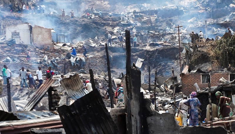 Congolese civilians gather as they attempt to extinguish fire at a school and neighbouring settlement in the area controlled by Rwanda-backed AFC/M23 rebels since the group staged an offensive in eastern Congo in February 2025, in Bukavu, Democratic Republic of Congo, September 10, 2026. REUTERS/Victoire Mukenge