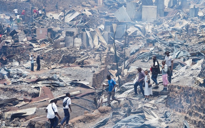 Congolese civilians gather as they attempt to extinguish fire at a school and neighbouring settlement in the area controlled by Rwanda-backed AFC/M23 rebels since the group staged an offensive in eastern Congo in February 2025, in Bukavu, Democratic Republic of Congo, September 10, 2026. REUTERS/Victoire Mukenge