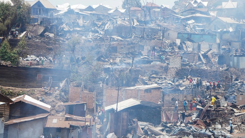 Congolese civilians gather as they attempt to extinguish fire at a school and neighbouring settlement in the area controlled by Rwanda-backed AFC/M23 rebels since the group staged an offensive in eastern Congo in February 2025, in Bukavu, Democratic Republic of Congo, September 10, 2026. REUTERS/Victoire Mukenge