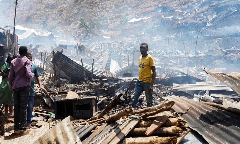 Congolese civilians gather as they attempt to extinguish fire at a school and neighbouring settlement in the area controlled by Rwanda-backed AFC/M23 rebels since the group staged an offensive in eastern Congo in February 2025, in Bukavu, Democratic Republic of Congo, September 10, 2026. REUTERS/Victoire Mukenge