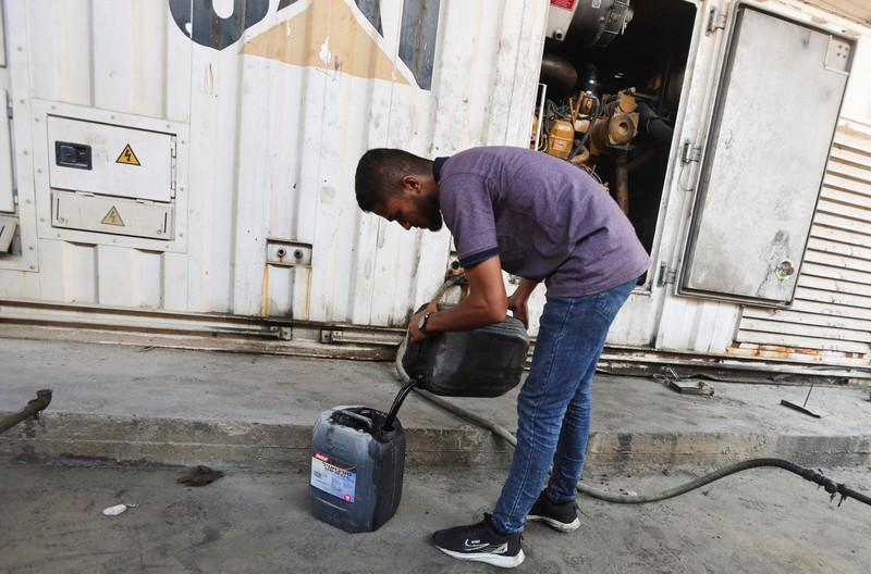 A Palestinian man lights a fire inside a tent amid shortages of electricity and fuel, in Khan Younis, in the southern Gaza Strip, September 5, 2026. REUTERS/Ramadan Abed