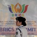 FILE PHOTO: A member of the Central Reserve Police Force (CRPF) stands in front of a hoarding displayed near Bharat Mandapam, the venue of the upcoming BRICS Summit in New Delhi, India, September 9, 2026. REUTERS/Bhawika Chhabra/File Photo