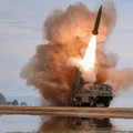 FILE PHOTO: A rocket launcher fires a munition during tests, involving an upgraded version of a 240-mm, 24-tube multiple rocket launcher system, tactical ballistic missiles, and a 155-mm self-propelled howitzer, overseen by North Korean leader Kim Jo