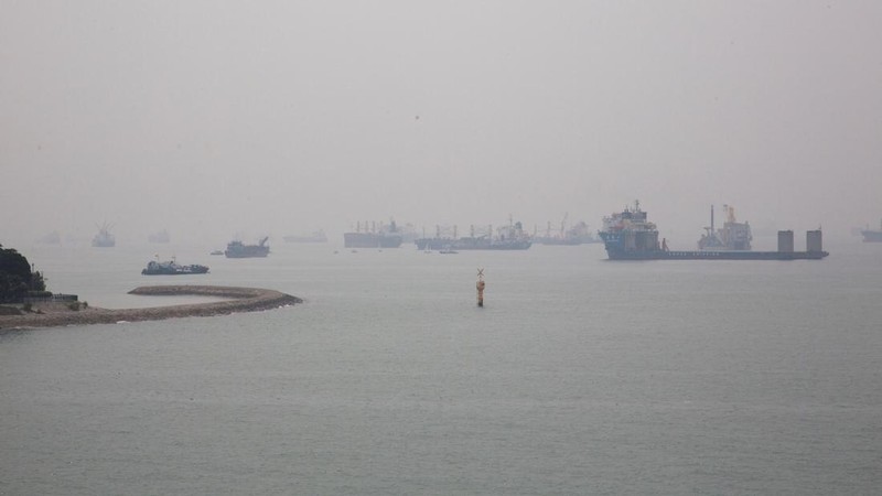 Kapal-kapal terselimuti kabut asap di sepanjang garis pantai Singapura, 15 September 2026.