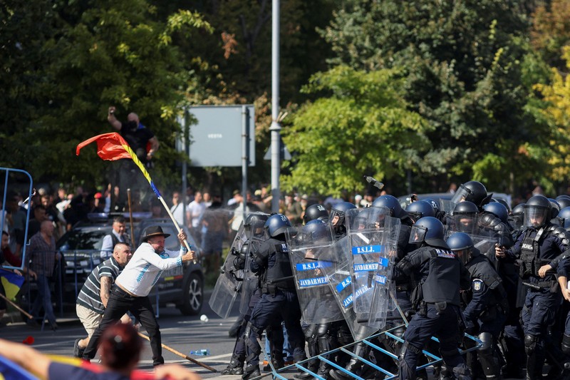 Para penggembala domba asal Rumania dan pendukung mantan calon presiden Calin Georgescu bentrok dengan petugas gendarmeri dalam sebuah unjuk rasa di depan kantor pusat pemerintah Rumania di Bukares, Rumania, pada 15 September 2026. (Inquam Photos/George Calin via REUTERS)