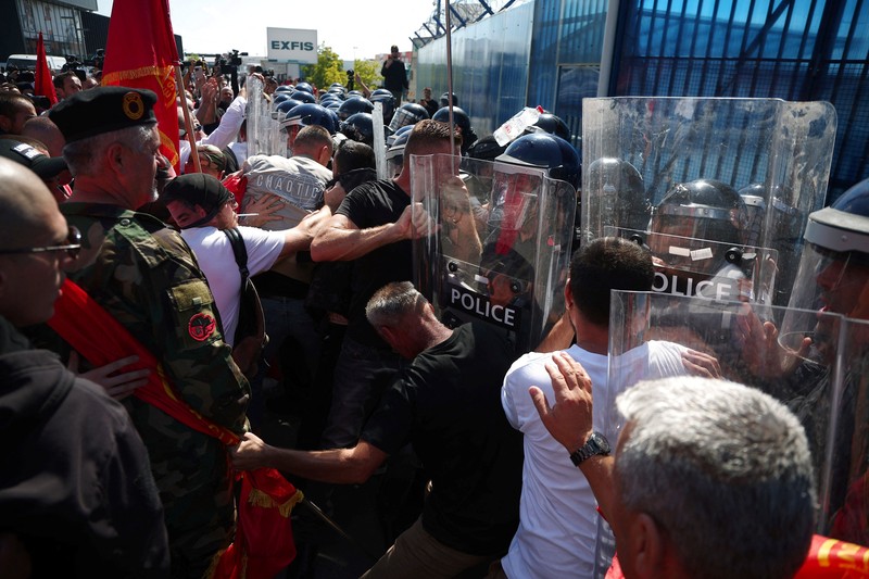 Seseorang memegang suar asap saat para pendukung mantan Presiden Kosovo Hashim Thaci berkumpul di Pristina, Kosovo, pada 16 September 2026&mdash;hari ketika Thaci dan mantan anggota Tentara Pembebasan Kosovo (KLA) lainnya mendengarkan putusan dalam sidang pengadilan kejahatan perang mereka di Kosovo Specialist Chambers di Den Haag. (REUTERS/Florion Goga)