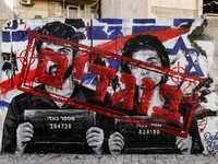 Graffiti depicting Yuval Abraham and Rachel Szor, the directors of the documentary film NAZA, and the word "traitors" in Hebrew, on a wall in Ashdod, southern Israel, September 15, 2026. NAZA was awarded the Special Jury Prize at the Venice Film Fest