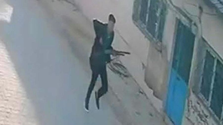 This handout photograph taken and released on September 22,2026 by Turkish news agency DHA (Demiroren News Agency) shows a CCTV image of a gunman running near a school in Turgutlu, an area west of the resort city of Izmir. A gunman opened fire outsid