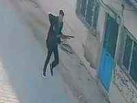 This handout photograph taken and released on September 22,2026 by Turkish news agency DHA (Demiroren News Agency) shows a CCTV image of a gunman running near a school in Turgutlu, an area west of the resort city of Izmir. A gunman opened fire outsid