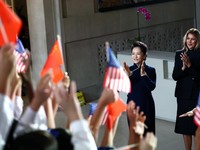 First lady of China Peng Liyuan and U.S. first lady Melania Trump react as choir students from the Hope Chinese School perform during a visit to the Smithsonian's National Museum Of Asian Art from Director of the museum Chase Robinson in Washington,