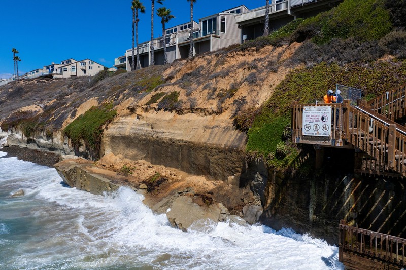 A drone view shows waves crashing into a boardwalk in Long Beach, California, US, September 16, 2026. REUTERS/Daniel Cole