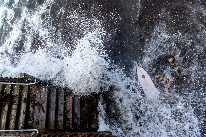A drone view shows waves crashing into a boardwalk in Long Beach, California, US, September 16, 2026. REUTERS/Daniel Cole