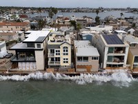 A drone view shows waves crashing into a boardwalk in Long Beach, California, US, September 16, 2026. REUTERS/Daniel Cole