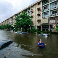 People wade through a flooded street during heavy rain in Bangkok, Thailand, September 26, 2026. REUTERS/Patipat Janthong