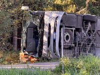 An overturned tour bus lies on the motorway A96 after a crash, killing two people and injuring several others, near Landsberg am Lech, Germany, September 27, 2026. REUTERS/Christine Uyanik