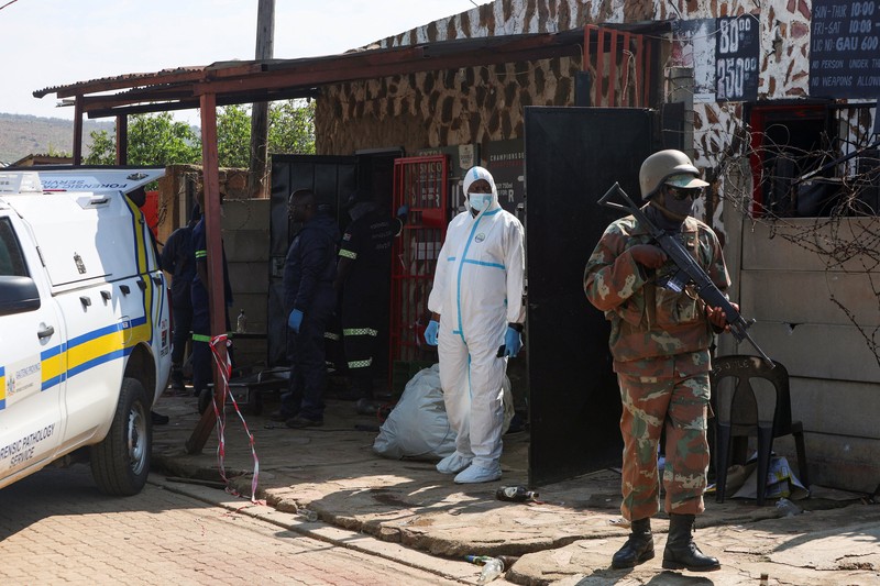 Blood stains on the ground next to an emergency vehicle at the site of a deadly shooting at a tavern in Wedela township, southwest of Johannesburg, South Africa, September 27, 2026. REUTERS/Oupa Nkosi