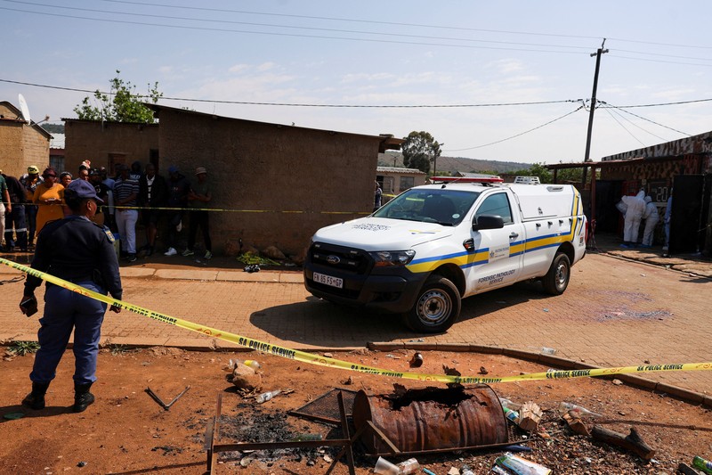 Blood stains on the ground next to an emergency vehicle at the site of a deadly shooting at a tavern in Wedela township, southwest of Johannesburg, South Africa, September 27, 2026. REUTERS/Oupa Nkosi