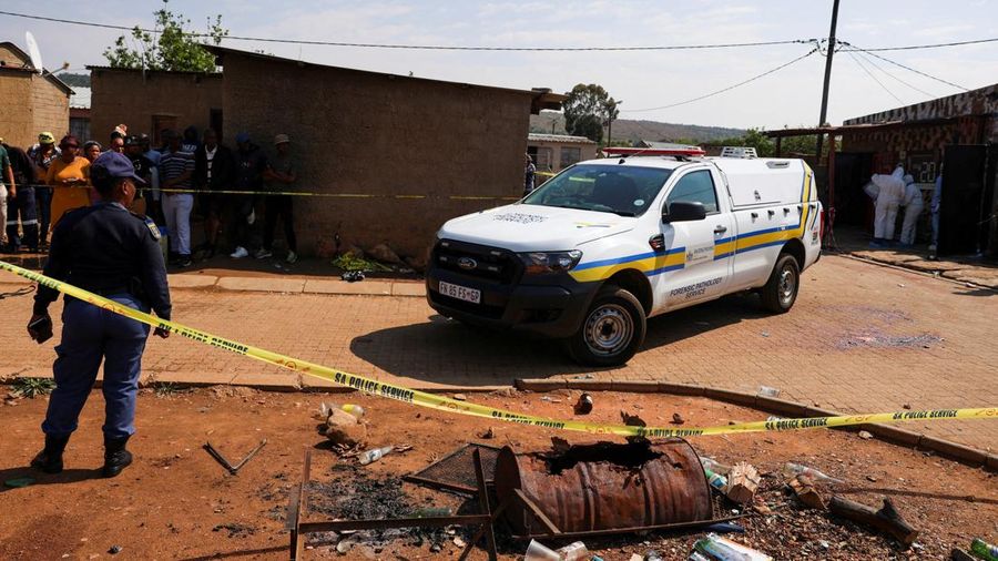 Blood stains on the ground next to an emergency vehicle at the site of a deadly shooting at a tavern in Wedela township, southwest of Johannesburg, South Africa, September 27, 2026. REUTERS/Oupa Nkosi